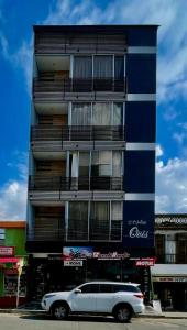 a white car parked in front of a building at 501S Estilo y Confort en Ibagué in Ibagué
