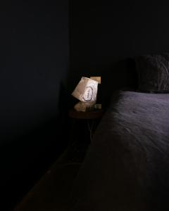 a bag of towels sitting on a table next to a bed at Hektor - farm, arts & suites in Teguise +62 photos