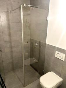 a shower stall with a toilet in a bathroom at Eastside Stay in Frankfurt