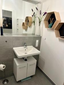a bathroom with a sink and a mirror at Eastside Stay in Frankfurt