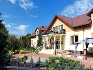 a house with a balcony and a patio at Sala Gracja in Zambrów