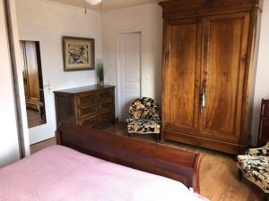a bedroom with a bed and a dresser and a chair at maison vacances COLLIOURE in Collioure +26 photos