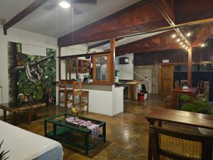 a living room with a table and a kitchen at Nuestra Casa in San Juan del Sur