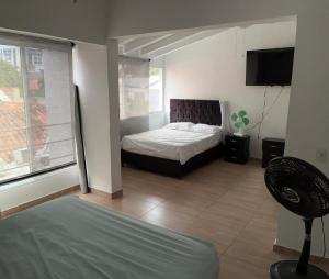 Ένα ή περισσότερα κρεβάτια σε δωμάτιο στο Casa Luz El Rodadero