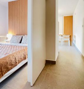 a bedroom with a bed and a dining room at Apartamento La Marina Azul el Puerto de Lo Pagan in San Pedro del Pinatar