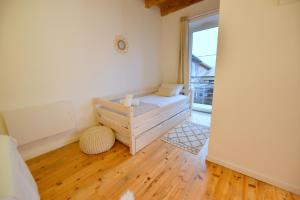 a bedroom with a bed and a large window at Maison de village wifi - parking et jardin privé in Grésy-sur-Isère