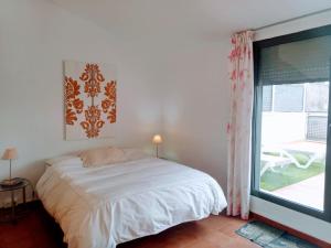 a bedroom with a bed and a large window at Loft El Carmen in Teruel