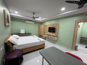 a hospital room with a bed and a tv at Yanam resorts in Yanam