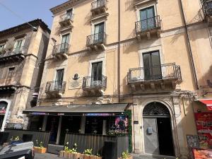a building with balconies on the side of it at Bellini Luxury Suite Superior in Catania