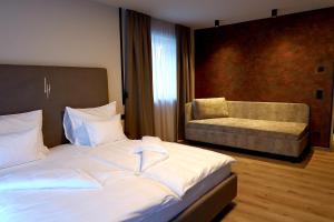 Ένα ή περισσότερα κρεβάτια σε δωμάτιο στο LH Suites Aparthotel NEW OPENING inkl JokerCard