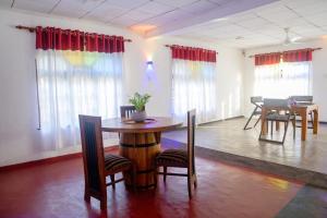 a room with a table and chairs and a dining room at Sunshine Hotel in Hikkaduwa