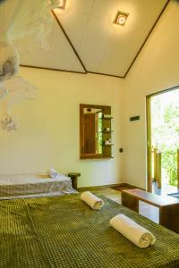 a room with two beds with towels on them at EdenHaven Cottage in Udawalawe +178 photos