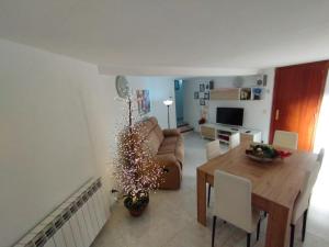 a living room with a table and a christmas tree at Casa Vitoria in Monroyo