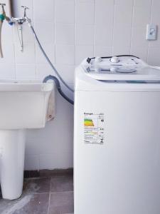 a bathroom with a toilet and a water hose at Espaço IN 1 Suite Brooklin mobiliado in Sao Paulo