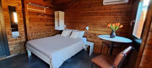 a bedroom with a bed and a table with a vase of flowers at Guesthouse Purmerend near Amsterdam Volendam in Purmerend