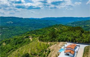 an aerial view of a house on a hill with mountains at Villa Bella Draguc in Draguć