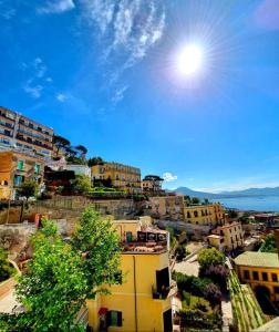 a city with buildings and the sun in the sky at Casa Dolce Casa Luxury in Naples
