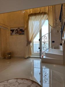 a living room with a large window and a table at Casa Dolce Casa Luxury in Naples