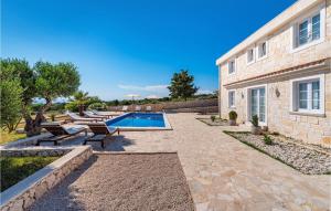 a patio with a swimming pool and a house at Villa Toma in Škunca