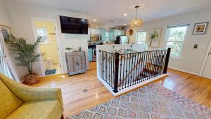 a living room with a couch and a kitchen at Flip Flop Casual in Folly Beach