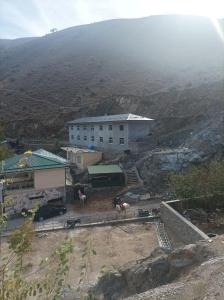 a building on top of a hill with a mountain at Hazrati Dovud Guest House in Samarkand