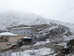 a building on a hill with snow on it at Hazrati Dovud Guest House in Samarkand
