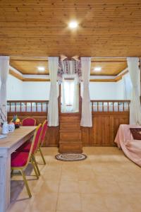 a dining room with a table and chairs in a room at Kouri Traditional House in Karpathos Town