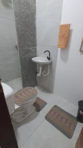 a bathroom with a toilet and a sink at FLAT BRISA do MAR in Pitimbu