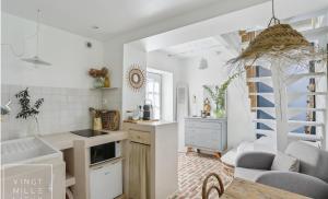 a kitchen and living room with white walls at Le Nichoir in Frélinghien
