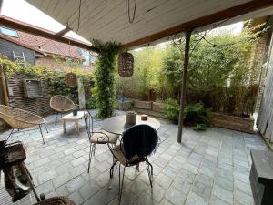 a patio with a table and chairs on a patio at Le Nichoir in Frélinghien