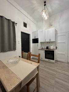 a kitchen and dining room with a table and chairs at Nina Center Apartment in Skopje