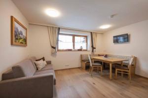 a living room with a couch and a table at Hieser's apartments in Neustift im Stubaital +23 photos