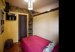 a bedroom with a red bed in a room with a window at Casa Yamba in Montojo