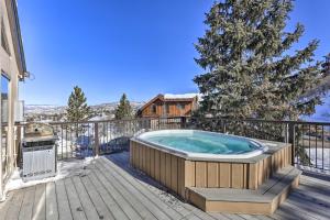 a hot tub on the deck of a house at Steamboat Ski Getaway with Balcony and Resort Views! in Steamboat Springs
