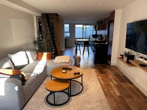 a living room with a couch and a table at Charmante Maison in Abrest