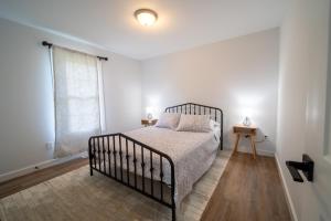 a bedroom with a bed and a window at Southern Serenity Cottage in Wendell