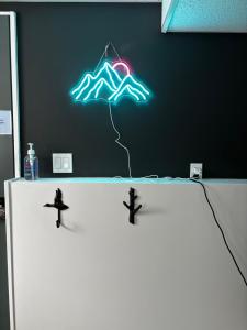 a neon sign on a wall with a kite at Amazing Views, Northern Lights, Stargazing Entire Guest Suite in Golden, BC Canada in Golden