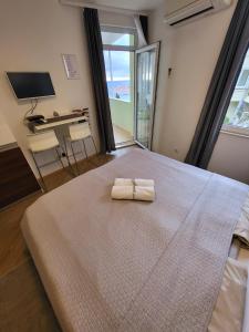 Postel nebo postele na pokoji v ubytování Blue Star Apartments
