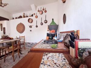 a kitchen with a table and a stove in a room at Nuragic Temple in Esterzili +45 photos