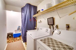 a laundry room with a washer and dryer at Seaside Home on the Space Coast with Beach Access! in Indialantic +22 photos