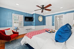 a bedroom with a bed and a ceiling fan at The Cavalier in Alexandria