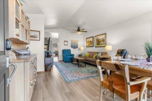 a kitchen and living room with a table and a couch at Blue Grass Bungalow in Coeur d'Alene