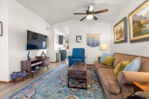a living room with a couch and a tv at Blue Grass Bungalow in Coeur d'Alene