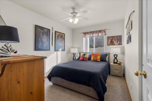 a bedroom with a bed and a ceiling fan at Blue Grass Bungalow in Coeur d'Alene
