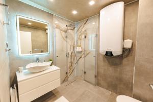 a bathroom with a sink and a mirror and a shower at Simaya, your home in the heart of Sandanski in Sandanski +25 photos