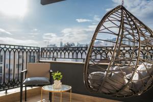 a room with a chair and a swing on a balcony at Simaya, your home in the heart of Sandanski in Sandanski