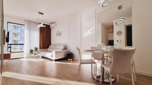 a living room with a table and a couch at White Pearl, Casa Al Mare in Rafailovici