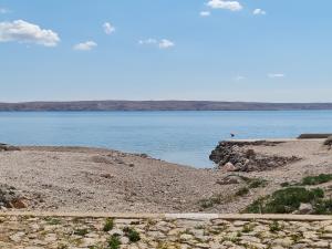 a large body of water with a rocky shore at Manta in Lukovo Šugarje