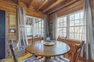 a wooden dining room with a wooden table and chairs at Bear’s Den in Sautee Nacoochee