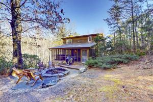 a small house in the middle of a forest at Bear’s Den in Sautee Nacoochee